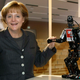 Image for article titled Why Is Angela Merkel Always Palling Around With Robots?